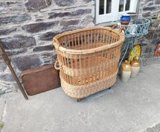large wicker Laundry / Bakery Basket on wheels 34" long