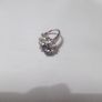 a silver dress ring with 10 white stones and purple stone Image 2