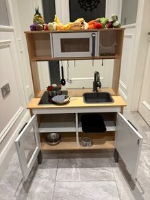 kids play kitchen complete with pots, pans,utensils and food (meat,fosh,fruit and veg)