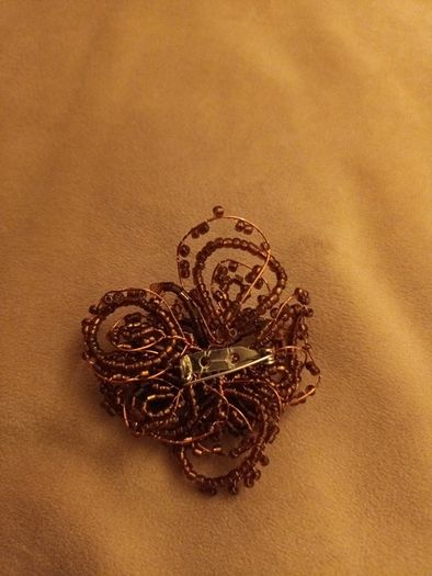 Beaded copper colour brooch