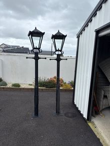 2   6 ft high lawn lights with one head.
