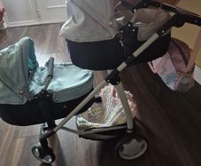 Twin pram and changing bag and 3 dolls