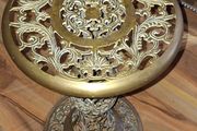 A Beautiful Old Hollywood Regency Brass Filigree Plant Stand Ornate Scrollwork features intricate, ornate pierced cut-work in a circular design