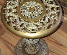 A Beautiful Old Hollywood Regency Brass Filigree Plant Stand Ornate Scrollwork features intricate, ornate pierced cut-work in a circular design