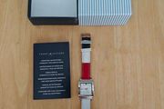 Tommy Hilfiger watch features a distinctive rectangular stainless steel case and a reversible red, white, and blue leather strap