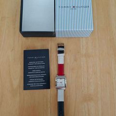 Tommy Hilfiger watch features a distinctive rectangular stainless steel case and a reversible red, white, and blue leather strap