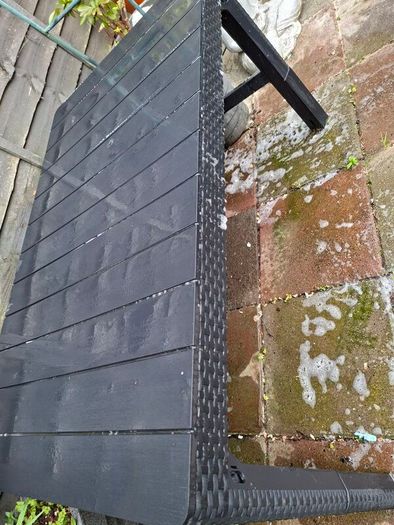 Black hard plastic garden or pargola table
