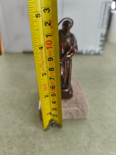 Copper Sacred art statue of Saint Francis of Assisi on marble plinth.