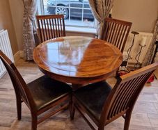 Round wooden table and four chairs