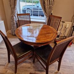 Round wooden table and four chairs