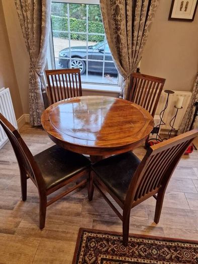 Round wooden table and four chairs