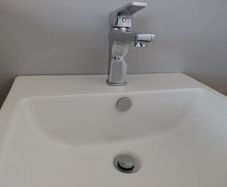 Wall hung bathroom sink with chrome Tap
