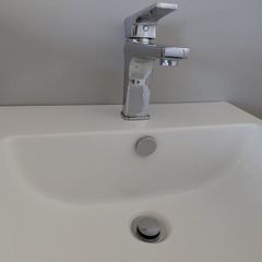 Wall hung bathroom sink with chrome Tap