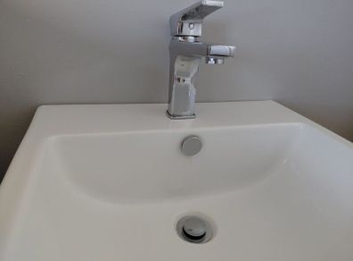 Wall hung bathroom sink with chrome Tap