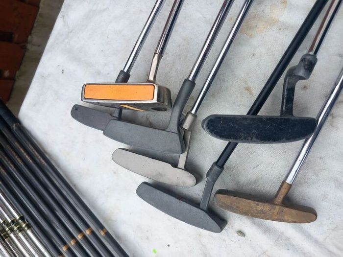 A selection of Golf clubs. Bags and golf balls.