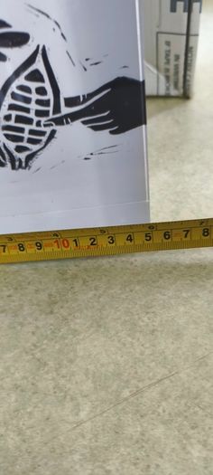 2 Papper Weight , Brass Papper Weight marked ISLAND 12.00 euro. Cleare Risen Tile Papper Weight.with black velvet on the back.10.00 euro.
