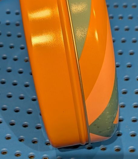Colourful circular tin box
