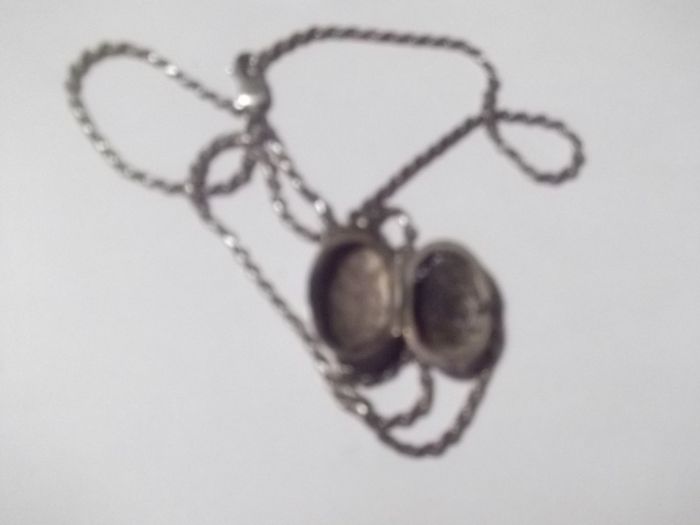 a silver locket with a silver chain