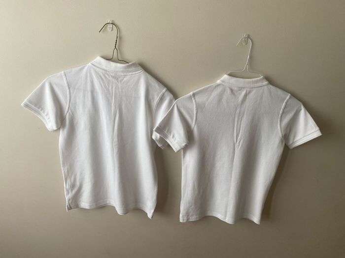 2 dunnes white polo shirts (as new) age 9-10