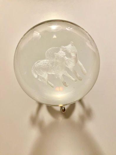 Beautiful glass ball with hologram  of  wolfs inside it
