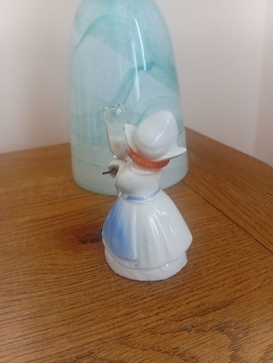 vintage porcelain egg timer featuring a dutch girl in traditional dress
