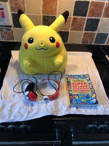 Pokemon items plush large Pikachu, Pokemon headphones and deluxe essential handbook