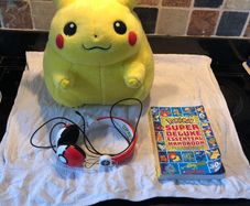 Pokemon items plush large Pikachu, Pokemon headphones and deluxe essential handbook