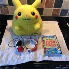Pokemon items plush large Pikachu, Pokemon headphones and deluxe essential handbook