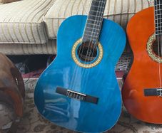 2 guitars with covers and one stand