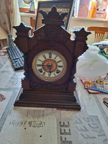 Lovely Ansonia New York Victorian Bracket clock ca 1880s. Original Enamel Dial and fine ornate black hands. 8 day gong striking Ansonia movement. Carved stepped base ornate case with gold tone brass bezel and pillars either side of the front. Good conditi