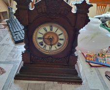 Lovely Ansonia New York Victorian Bracket clock ca 1880s. Original Enamel Dial and fine ornate black hands. 8 day gong striking Ansonia movement. Carved stepped base ornate case with gold tone brass bezel and pillars either side of the front. Good conditi