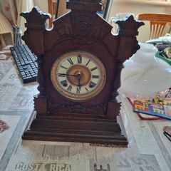 Lovely Ansonia New York Victorian Bracket clock ca 1880s. Original Enamel Dial and fine ornate black hands. 8 day gong striking Ansonia movement. Carved stepped base ornate case with gold tone brass bezel and pillars either side of the front. Good conditi