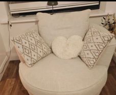 OPEN TO REASONABLE OFFERS.... PRICE DROP SWIVEL ARM CHAIR brand new with matching cushions   cost 950 selling reluctantly 450 due to moving to smaller  house