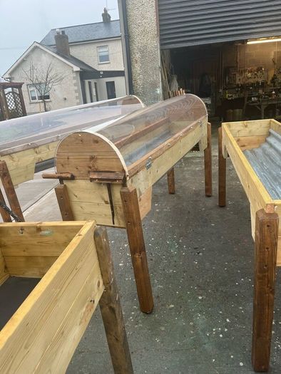Raised beds bird feeders and cast iron benches