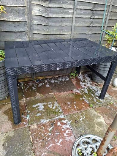 Black hard plastic garden or pargola table