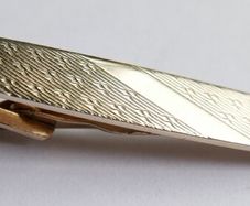 Gold plated tie clip with textured detail