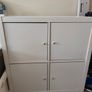 IKEA KALLAX 2x2 storage unit in white, fitted with 4 individual cupboard door inserts. Image 2