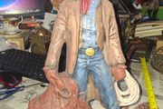 Large Vintage Ceramic Cowboy Figurine Hand Painted brown jacket and a detailed saddle resting at his feet Postage Available or Collection