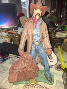 Large Vintage Ceramic Cowboy Figurine Hand Painted brown jacket and a detailed saddle resting at his feet Postage Available or Collection