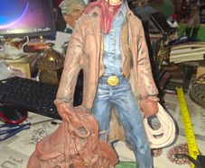 Large Vintage Ceramic Cowboy Figurine Hand Painted brown jacket and a detailed saddle resting at his feet Postage Available or Collection
