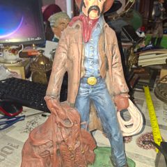 Large Vintage Ceramic Cowboy Figurine Hand Painted brown jacket and a detailed saddle resting at his feet Postage Available or Collection
