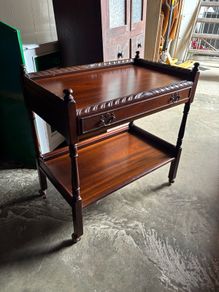 A mahogany cutlery trolley