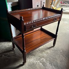 A mahogany cutlery trolley