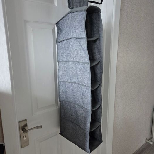 Grey fabric hanging closet organizer with 6 open shelves and side mesh pockets