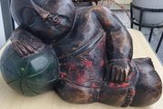 A large wooden statue of a sleeping Buddha