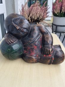 A large wooden statue of a sleeping Buddha