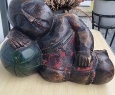 A large wooden statue of a sleeping Buddha