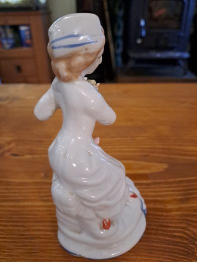 Vintage porcelain woman figurine detailed flowers