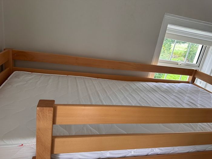 Bunk bed with attached slide and mattresses