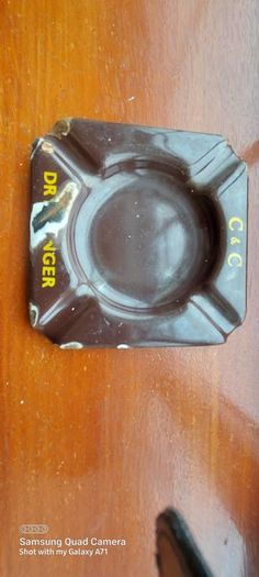 C & C Dry Ginger "ale" enamel metal ashtray ,dark brown,  very old vintage advertising ashtray, hard to come by ,collectors item,used condition  see pictures